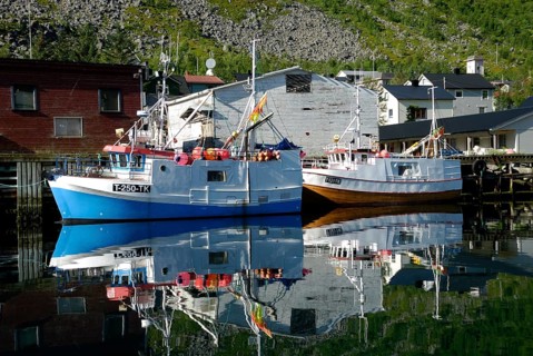 Fishing boats reflected in the Gryllefjord, Senja, Troms, Norway, Europe