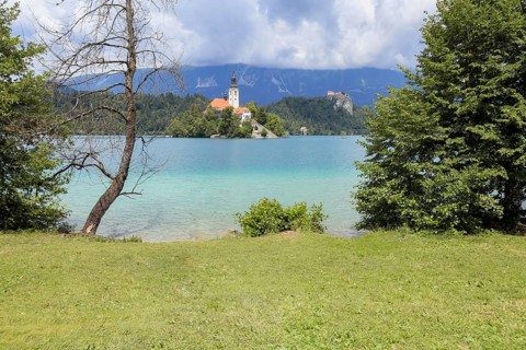 Lake Bled Slovenia. Beautiful mountain lake in summer with small Church on an island with castle on