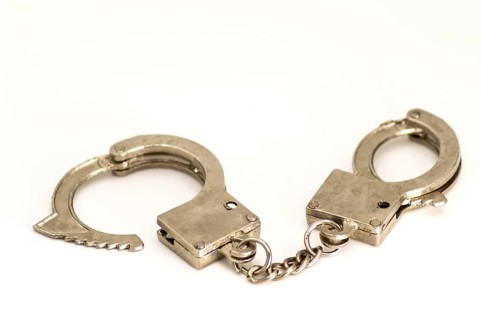 Pair of handcuffs close up front view on a white background