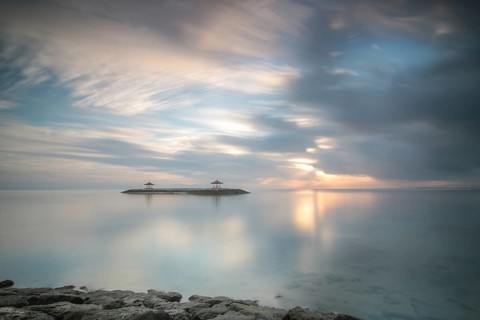 Beautiful seascape in the morning. Tropical sandy beach with breakwater and reflection of the sky