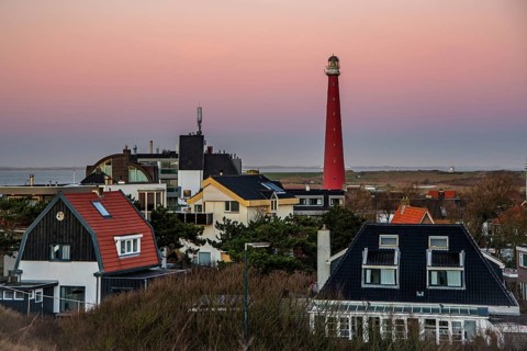 Huisduinen, the Netherlands. january 2022. Setting sun over the village and the lighttower.