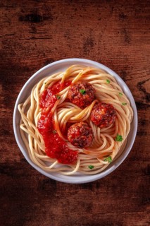 Meatballs. Beef meat balls, shot from above with spaghetti pasta, parsley, and tomato sauce, on a
