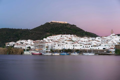 Sanlucar de Guadiana in Spain and Alcoutim in Portugal with sail boats on Guadiana river