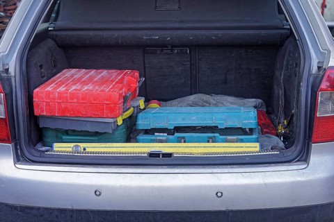Boxes of work tools in car trunk
