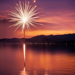 Sparkler glowing at sunset over a lake, reflecting on the water with mountains in the background,
