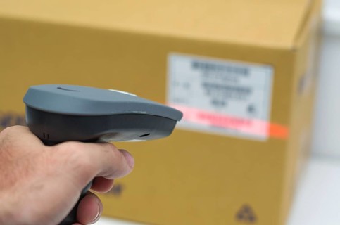 Great concept of traceability, ERP system, hand crawling product barcode and packaging. The man