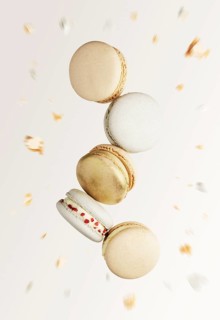 White, yellow, gold macaron cookies. Colorful, sweet small French macaroon cakes. Light beige