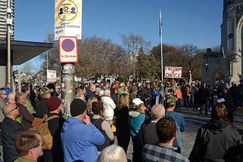 CHRISTCHURCH, NEW ZEALAND, JULY 24, 2021, The crowd ignores social distancing signage at a protest