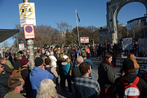 CHRISTCHURCH, NEW ZEALAND, JULY 24, 2021, The crowd ignores social distancing signage at a protest