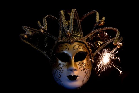 Den Helder, the Netherlands. December 2022. Venetian carnaval mask on black background with sparks.