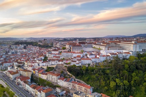 Coimbra drone aerial of beautiful buildings university at sunset, in Portugal