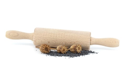 Dried poppy pods and poppy seeds in front of the rolling pin isolated on white background, full