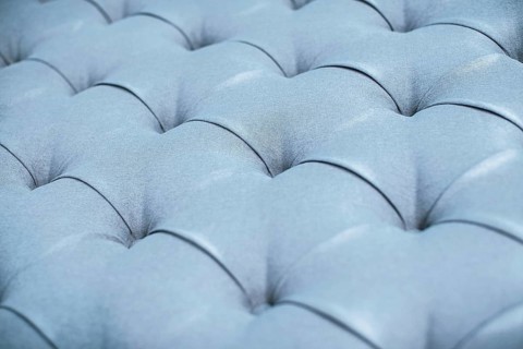Blue gray upholstered furniture from ement quilted fabric texture. Interior design, headboards made