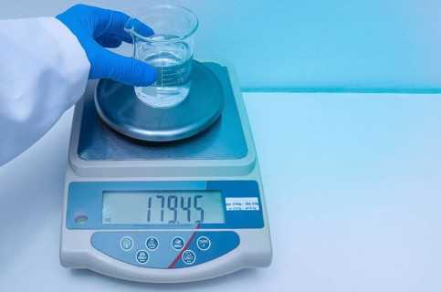 Great concept of research and development, hand weighing chemicals on precision scale