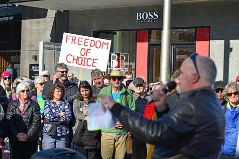 CHRISTCHURCH, NEW ZEALAND, JULY 24, 2021, A man speaks at a protest rally at the Bridge of