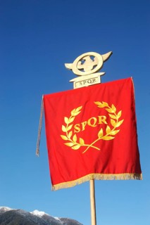 Roman Standard displaying SPQR, against blue sky and alps