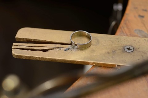 A gold ring cut and ready to be made smaller