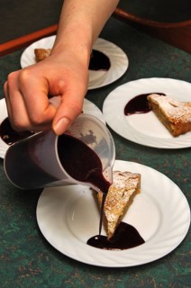 Cooks adding sauce to delicious homemade apple pies