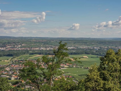 A wide view of a town and fields, surrounded by trees and clouds in the sky, Dürnstein, Wachau,
