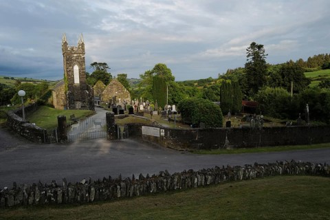 A view of the Church and graveyard near St Gobnait's well in Cúil Aodha in West Cork on a sunny