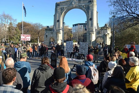 CHRISTCHURCH, NEW ZEALAND, JULY 24, 2021, People gather at a protest rally at the Bridge of