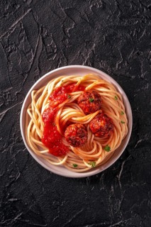 Meatballs. Beef meat balls, shot from above with spaghetti pasta, parsley, and tomato sauce, on a