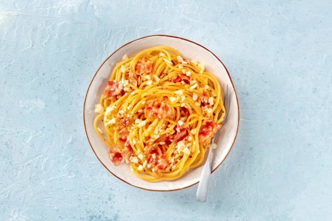 Carbonara pasta dish, traditional Italian spaghetti with pancetta and cheese, overhead flat lay