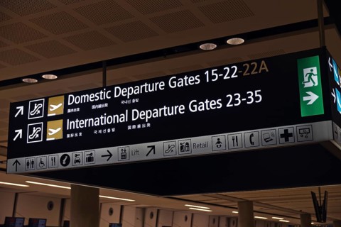 Airport signage directing passengers on international and domestic flights