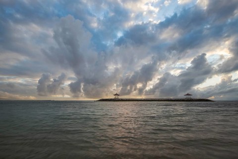 Beautiful seascape in the morning. Tropical sandy beach with breakwater and reflection of the sky
