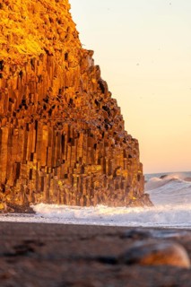 Detail of volcanic formations on the black sand beach of Reynisfjara at sunset in Iceland