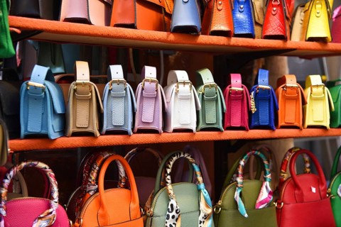 Florence, Italy. September 2023. Souvenir stalls with colorful handbags in Florence