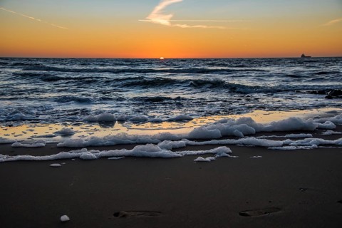 Den Helder, Netherlands. January 2022. Setting sun on the beach of Den Helder, Netherlands.