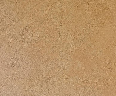 Light beige, roughly plastered house wall as full-format background