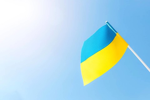 Large bicolor yellow blue Ukrainian state flag, national symbol fluttering, waving in wind against
