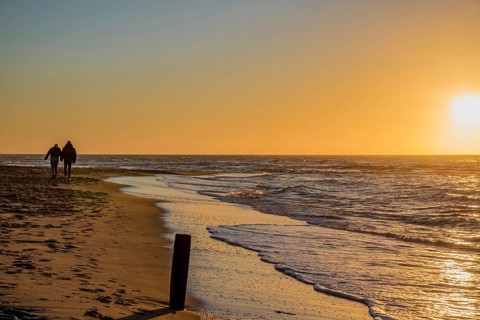 Den Helder, Netherlands. January 2022. Setting sun on the beach of Den Helder, Netherlands.
