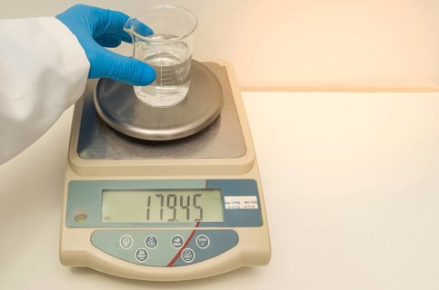 Great concept of research and development, hand weighing chemicals on precision scale