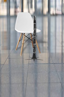 Clarinet and a white chair in an auditorium