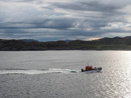 A pilot boat sails along the Norwegian coast