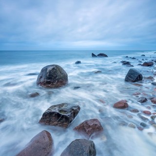 Stormy Baltic Sea in winter, boulders in the surf, near Rerik, Mecklenburg-Western Pomerania,