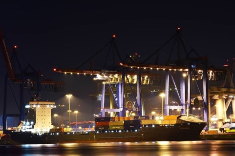 Container ships being loaded at night at the container terminal Burchardkai, Hamburg, Germany,