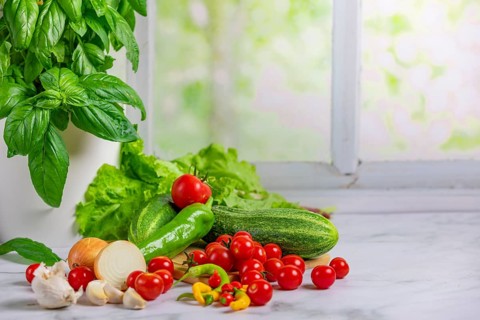 Fresh vegetables, salad ingredients, cucumber, tomatoes, lettuce, basil, pepperoni, onion cut,