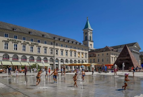 Children playing at the water games on the market place, Karlsruhe, Baden-Württemberg, Germany,