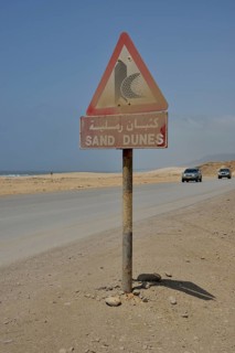 Warning sign warns of sand dunes, near Mirbat, Dhofar Region, Oman, Asia