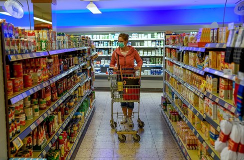 Woman wearing a face mask while shopping in a supermarket, Corona crisis, pandemic,