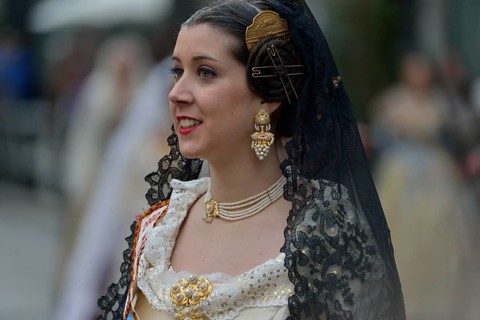 Fallas festival, woman in a traditional costume during the parade in the Plaza de la Virgen de los