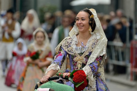 Fallas festival, young woman in a traditional costume during the parade in the Plaza de la Virgen