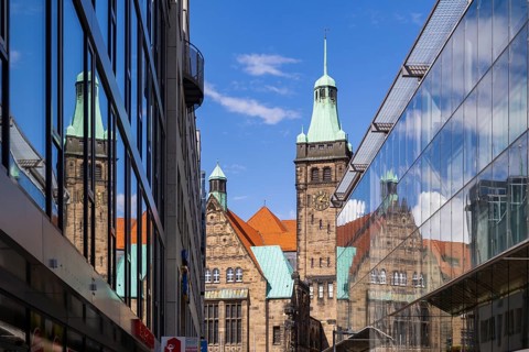 View through Bretgasse to the town hall with the reflection in Galeria Kaufhof