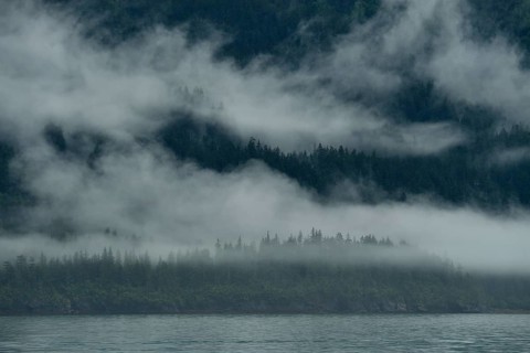 The westerly wind pushes the clouds against the steep slopes of the Chugach Mountains, the moisture
