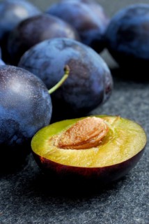Plums (Prunus domestica) , plum, plum, plum, plum, halved