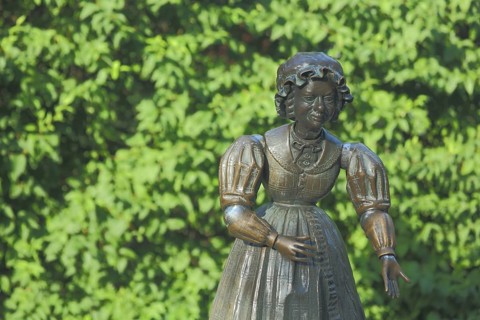 Sculpture and figure as a woman with Biedermeier clothing at the Datterich fountain at Luisenplatz,